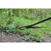 Close-up of DD Hammocks Whoopie Suspension System with tree-friendly straps in a natural setting.